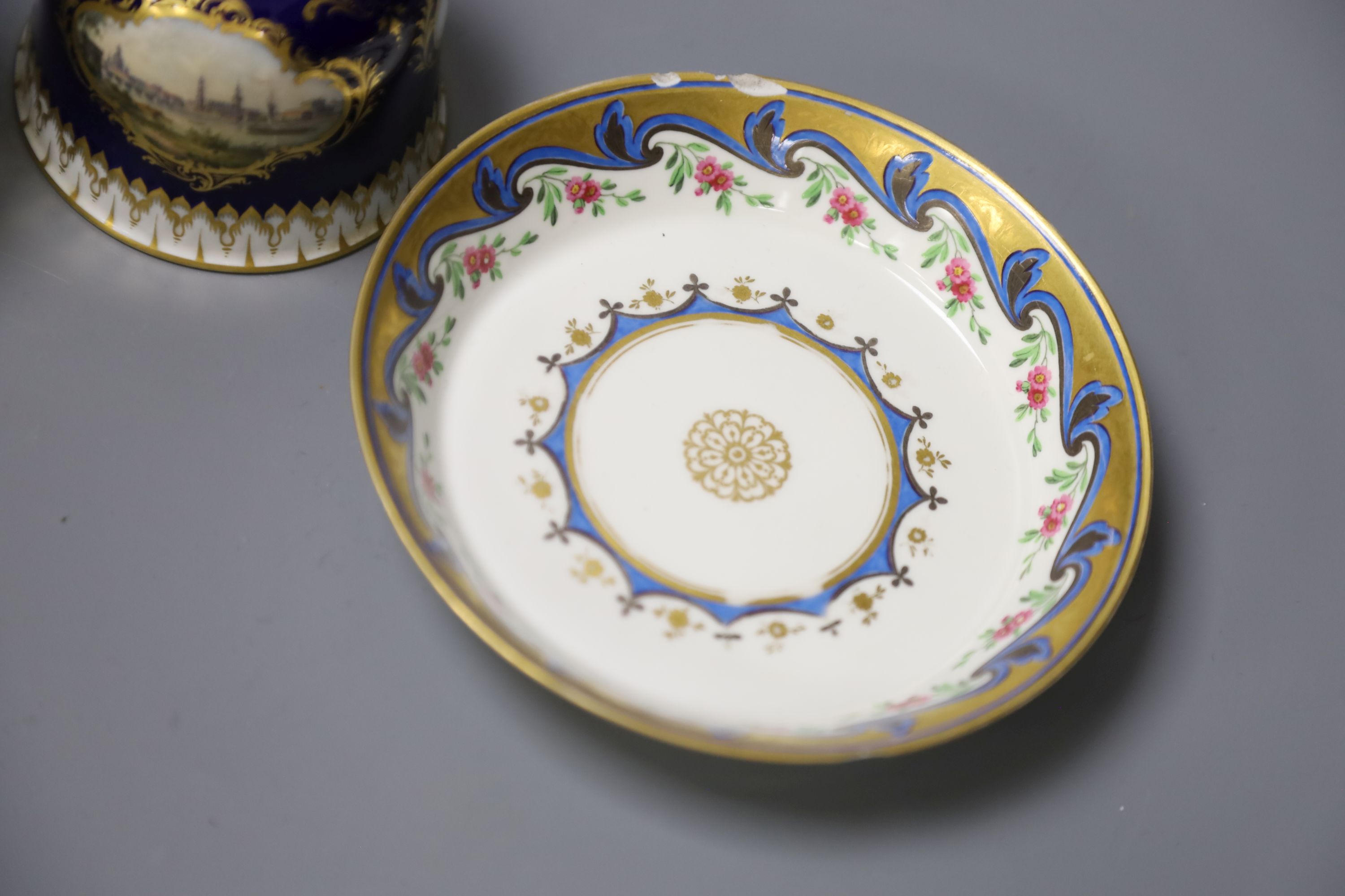 A Meissen hand-painted table bell, a Vienna saucer, diameter 13.5cm, and a Sevres cup